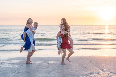 Golden-hour family portrait at sunset on Clearwater beach by Henry M Production
